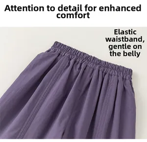 Detail view of the purple elastic waistband on children's loose cotton linen trousers