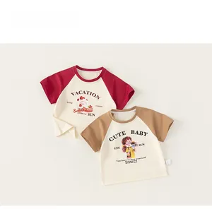 Flat lay of two raglan cotton t-shirts with strawberry and vintage girl cartoon prints