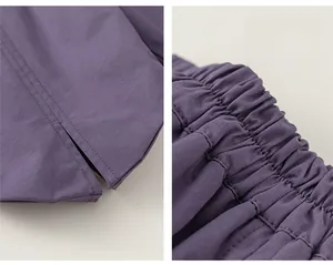 Detailed view of elastic waistband and split hem design on purple girls trousers