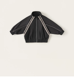 Detail of a black boys sports jacket with stand-up collar and beige stripes
