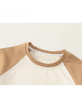 Close-up of brown and cream raglan T-shirt neckline with CUTE B print and neat stitching