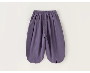 Detail shot of purple kids harem pants featuring elastic waist and stylish side split cuffs
