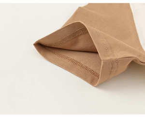 Detailed close-up of hem stitching and soft cotton knit texture on a khaki toddler T-shirt