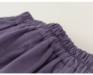 Detailed close-up of dark purple elastic waistband with fine stitching and cotton texture