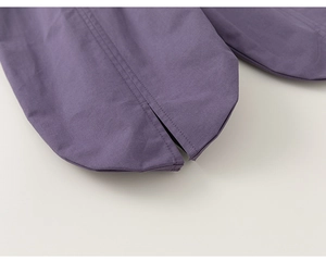 Detail view of purple girls' pants featuring split hem design and premium stitching