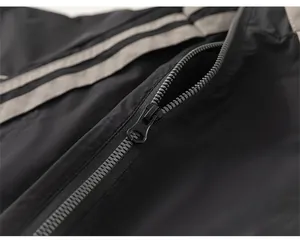 Close-up of durable black metal zipper on boy's sporty jacket with grey stripe details