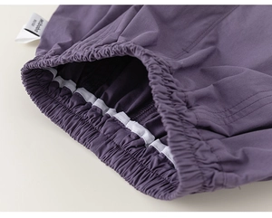 Macro detail of elastic waistband and inner stitching on purple children's trousers