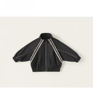 Detailed flat lay of boys black sports jacket with zip-up collar and grey sleeve stripes