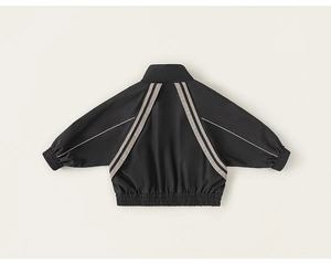 Detail view of black kids sports jacket with V-shaped gray stripes and ribbed elastic cuffs