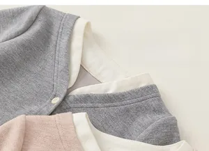 Close-up of girls knitted cardigan with faux two-piece design and soft ribbed texture