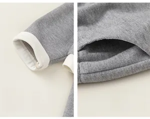 Detail view of grey knit cardigan showing ribbed cuffs and functional side pockets