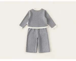 Detail view of girls gray knit tracksuit with contrast ribbing and wide-leg trousers