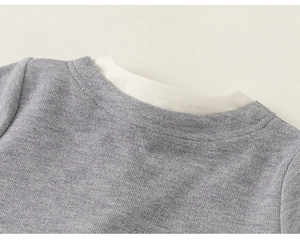 Close-up of girls' grey ribbed cardigan collar with white layered neckline detail