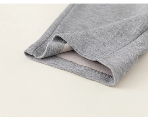 Detail shot of grey knit fabric showing soft inner fleece and neat stitching craftsmanship