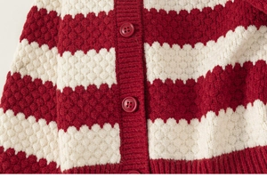Detailed close-up of red and white striped knit cardigan with textured bubble weave and buttons