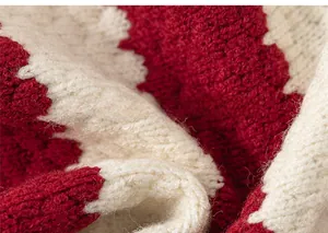 Close-up of red and white striped thick knit fabric showing warm fiber texture