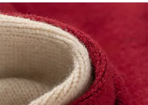 Detail of red knitted sweater for girls showing thick warm white inner lining fleece