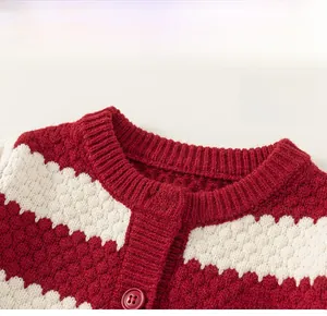 Detailed close-up of the classic round neckline and buttons on red striped cardigan