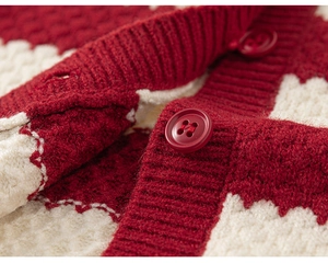 Detail of red knitted cardigan featuring geometric patterns and resin buttons