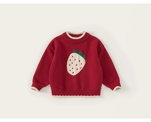 Close-up of a red knit sweater with white strawberry pattern and scalloped edges