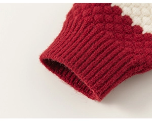 Close-up of girls' knit cardigan featuring burgundy ribbed cuffs and thick textured weave