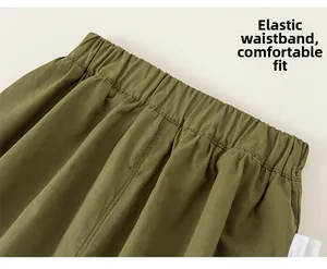 Detail view of army green cotton pants with elastic waistband and smooth ribbed texture