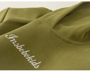 Detailaufnahme der weißen Logo-Stickerei auf dem olivgrünen Kinder-Strickkapuzenpullover