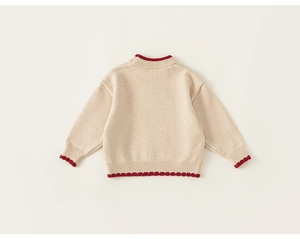 Close-up of the back view of a beige knit sweater featuring red scalloped trim details