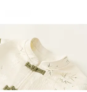 Detail of mandarin collar with green handmade frog buttons on bamboo pattern silk suit