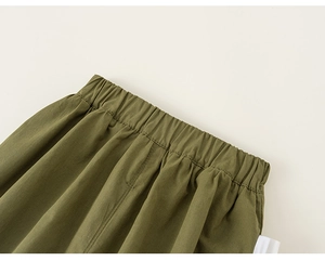 Detail shot of olive green kids trousers featuring a wide comfortable elastic waistband