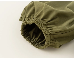 Detail of army green cotton boy's suit showing elastic ribbed cuffs and fine stitching
