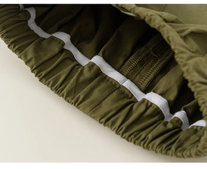 Close-up of elastic waistband with reinforced stitching on green cotton pants