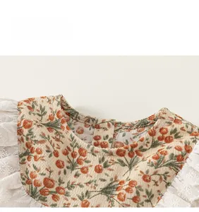 Détail d'une chemise en velours pour fille avec col en dentelle et motifs floraux