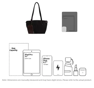 Detail view of large black suede tote bag with brown leather pouch and capacity icons