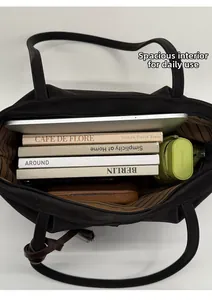Spacious black tote bag interior showing capacity for laptop, books, and daily essentials