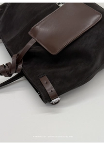 Detail showing high-quality contrast stitching and mixed suede-leather texture on tote bag