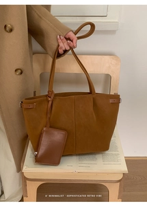 Close-up of retro brown tote bag with suede texture and matching hanging zipper pouch