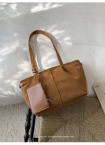 Close-up of brown retro tote bag with detachable coin purse and elegant buckle detail