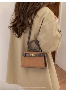 Detail of vintage crossbody bag with gold buckle on trench coat model in elegant indoor setting