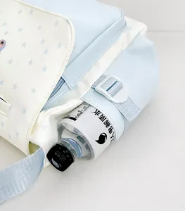 Close-up of the functional side pocket on this blue star-pattern canvas tote bag