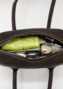 Detail view of large brown leather tote bag interior showing spacious storage space