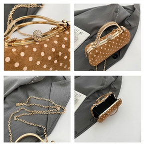 Detailed view of brown polka dot suede box bag with rhinestone handle and gold chain strap