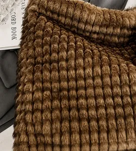 Detail of dark brown faux fur pleated texture with a soft woven cube pattern
