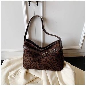 Close-up of vintage leopard print suede texture and premium gold metal hardware detail