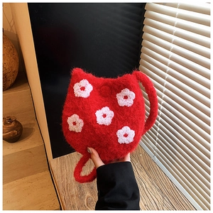 Detail of red plush kitten bucket bag featuring soft floral embroidery and cozy fur texture