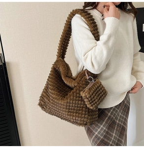 Macro shot of dark brown plush tote bag with checkered faux fur texture and small pouch