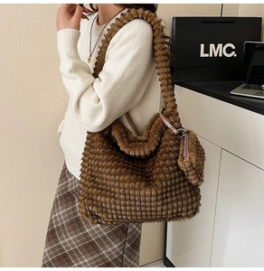 Detail of dark brown plush tote bag featuring a textured grid pattern and mini coin purse