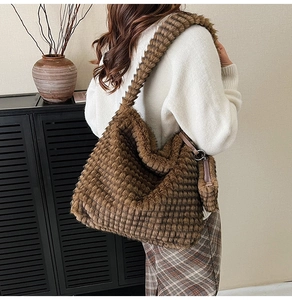 Brown plush tote bag featuring a textured grid pattern shown in a lifestyle shoulder view