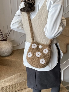Cute brown plush bucket bag with white floral embroidery and long shoulder strap
