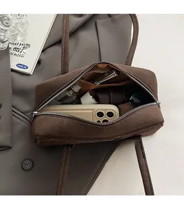 Macro shot of spacious dark brown suede interior with daily essentials and zipper detail